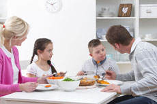 family in a home eating a meal